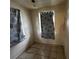 Small tiled bedroom with patterned curtains over two separate windows at 8302 N Lois Ave, Tampa, FL 33614