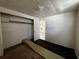 Simple bedroom featuring a closet, doorway to another room, and carpet that needs replacement at 8302 N Lois Ave, Tampa, FL 33614
