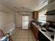 Compact kitchen with essential appliances and fixtures ready for updates at 8302 N Lois Ave, Tampa, FL 33614