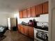 Functional kitchen with wood cabinets, a white refrigerator, and standard appliances at 8302 N Lois Ave, Tampa, FL 33614