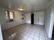 Functional living room features tile flooring, window AC and an attached closet at 8302 N Lois Ave, Tampa, FL 33614