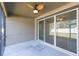 Enjoy the outdoor space of this patio featuring a ceiling fan and large sliding glass doors to the backyard at 12312 Bay Estuary Bnd, Riverview, FL 33579