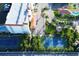 Overhead view of the tennis courts, pool, parking and residence; all surrounded by landscaping at 17717 Gulf Blvd # 601, Redington Shores, FL 33708