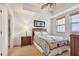 Inviting bedroom with a fan, a tray ceiling, and a window, offering a bright view and a tranquil setting at 17717 Gulf Blvd # 601, Redington Shores, FL 33708