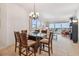 Bright dining room with a modern chandelier, seating for six, and views of the water at 17717 Gulf Blvd # 601, Redington Shores, FL 33708