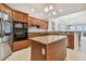 A modern kitchen with granite countertops, stainless steel appliances, and a center island for cooking prep at 17717 Gulf Blvd # 601, Redington Shores, FL 33708