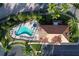 Overhead shot of the freeform pool and hot tub at a residence surrounded by palm trees at 17717 Gulf Blvd # 601, Redington Shores, FL 33708