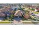 An inviting house boasts a tile roof, brick driveway, and well-maintained landscaping in a desirable neighborhood at 2564 Grand Cypress Blvd, Palm Harbor, FL 34684