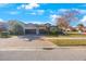 Lovely home exterior boasts a brick driveway, two-car garage, and mature landscaping at 2564 Grand Cypress Blvd, Palm Harbor, FL 34684