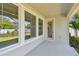 Covered back patio with large windows and a glass door, providing access to the landscaped backyard at 3218 21St N St, St Petersburg, FL 33713