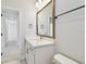 Modern bathroom with white vanity, gold hardware, and a large mirror over the sink at 3218 21St N St, St Petersburg, FL 33713