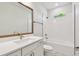 Modern bathroom with quartz countertop, bronze fixtures, and a shower-tub combo with white subway tiles at 3218 21St N St, St Petersburg, FL 33713