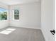 Bright bedroom featuring neutral carpet, white walls, and large windows providing great natural light at 3218 21St N St, St Petersburg, FL 33713