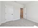 Spacious bedroom featuring neutral carpet, white walls, and white doors to other rooms and closets at 3218 21St N St, St Petersburg, FL 33713