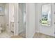 Bright entryway featuring a half bathroom, neutral walls, and a door with a window showcasing the exterior at 3218 21St N St, St Petersburg, FL 33713