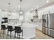 Modern white kitchen featuring a large center island with quartz countertops and stainless steel appliances at 3218 21St N St, St Petersburg, FL 33713