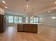 Kitchen with stainless steel dishwasher and large center island with bronze pendant lights at 3218 21St N St, St Petersburg, FL 33713