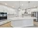 Spacious kitchen features a large island with white cabinets, stainless steel appliances, and modern pendant lighting at 3218 21St N St, St Petersburg, FL 33713