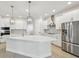 Bright kitchen with stainless steel appliances, quartz countertops, and modern pendant lighting at 3218 21St N St, St Petersburg, FL 33713