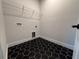 Modern laundry room with black and white tile and wire shelving at 3218 21St N St, St Petersburg, FL 33713