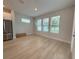 Bright open living room with plank flooring, lots of windows and stainless steel refrigerator at 3218 21St N St, St Petersburg, FL 33713