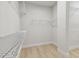 Well-organized walk-in closet featuring white wire shelving and laminate floors at 3218 21St N St, St Petersburg, FL 33713