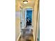 Hallway with slate flooring leads to a bright blue room with desk at 4231 Tamargo Dr # 3, New Port Richey, FL 34652