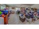 Spacious living room with a ceiling fan, light walls and lots of personal items at 783 Placido Ne Way, St Petersburg, FL 33704