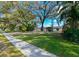 Well-manicured front lawn with mature trees shading this single-story residence, near the sidewalk at 821 Old Darby St, Seffner, FL 33584