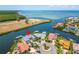 Stunning aerial view of waterfront home with lush landscaping and private dock at 1024 Sonata Ln, Apollo Beach, FL 33572