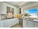 Well-lit kitchen features granite countertops, stainless steel appliances, and a large window at 1024 Sonata Ln, Apollo Beach, FL 33572