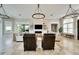 Bright living room with large windows, fireplace, and modern lighting fixtures at 1024 Sonata Ln, Apollo Beach, FL 33572