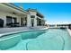 Gorgeous pool area featuring a covered patio and lounge chairs, perfect for relaxing at 1024 Sonata Ln, Apollo Beach, FL 33572