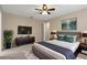 Primary bedroom featuring modern decor, a large bed, and a mounted flat screen tv at 1628 Baker Rd, Lutz, FL 33559