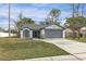 Charming single-story home with a well-manicured lawn, two-car garage, and inviting curb appeal at 1628 Baker Rd, Lutz, FL 33559