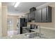 Galley kitchen features granite countertops and stainless steel sink at 1628 Baker Rd, Lutz, FL 33559