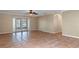 A bright and airy living room with tiled flooring and double doors leading to the backyard at 1628 Baker Rd, Lutz, FL 33559
