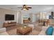 Bright living room with ample seating, a view into the kitchen, and neutral decor at 1628 Baker Rd, Lutz, FL 33559