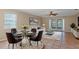 A cozy living room features a modern sofa, dining table, and large windows that let in natural light at 1628 Baker Rd, Lutz, FL 33559