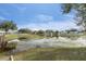 Beautiful backyard pond surrounded by lush greenery in a serene setting at 1628 Baker Rd, Lutz, FL 33559
