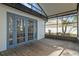Screened in back porch with wood floors and view of backyard at 1628 Baker Rd, Lutz, FL 33559