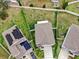 Aerial view of a house with solar panels and a large backyard with green space at 17102 Yellow Pine St, Wimauma, FL 33598