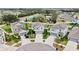 Aerial view of gray homes with well-maintained yards in a suburban neighborhood at 17102 Yellow Pine St, Wimauma, FL 33598