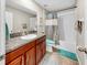 Bathroom with granite countertop, wood cabinets, and shower-tub combination at 17102 Yellow Pine St, Wimauma, FL 33598