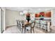 Open-concept dining area with a large dining table, pendant lighting, and kitchen access at 17102 Yellow Pine St, Wimauma, FL 33598