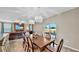 Open-concept dining room with modern pendant lighting and sliding glass doors to the backyard at 17102 Yellow Pine St, Wimauma, FL 33598