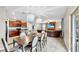 Dining area shows dark wood table and white chairs near the open kitchen and living room at 17102 Yellow Pine St, Wimauma, FL 33598