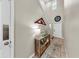 Bright foyer with high ceilings, decorated console table, tile flooring, and a white front door at 17102 Yellow Pine St, Wimauma, FL 33598