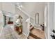 Inviting foyer featuring tile flooring, a staircase, decorative elements, and a view of the living space at 17102 Yellow Pine St, Wimauma, FL 33598