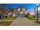 Two-story home with a gray exterior, attached garage, and well-manicured landscaping at 17102 Yellow Pine St, Wimauma, FL 33598